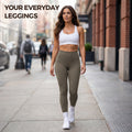 Woman walking down city street wearing olive green high-waisted everyday leggings and white sports bra